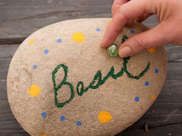 Add decorative touches by gluing colorful glass marbles or tiles onto the rock.