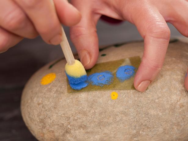Paint the designs you have in mind onto your decorative garden stone.