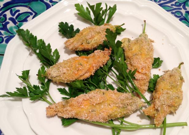 Baked stuffed squash blossoms on a bed of parsley Baked stuffed squash blossoms on a bed of parsley