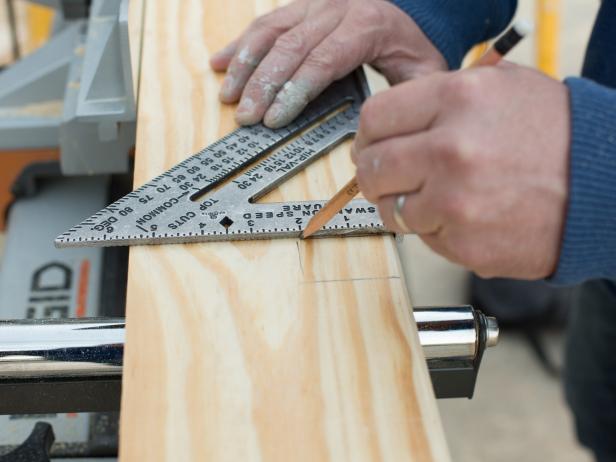 On the 2' x 6' plank of pine or cedar, mark the width of the door span, adding one additional inch to each side to account for proper overhang.