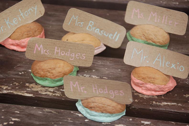 There are many opportunities to include your garden in wedding decorations, and one detail that shouldn't be overlooked is place cards. Beautiful place cards are a small touch that can really make an impact. These walnut shell place card holders are made by dipping the bottom half in paint that matches the wedding colors. Use a small saw to cut a slit across the top and place the name cards in for a beautiful display.