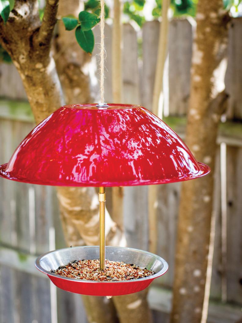 A stainless steel mixing bowl and pie tin from a thrift store were the perfect foundation for this cheery bird feeder. With just a few dollars worth of materials and very little time you can add some color to the yard while feeding your feathered friends.