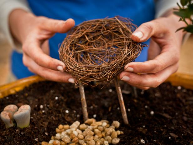 Use a mini "bird's nest" (you can find them in craft supply stores) and sticks to create a papasan chair.