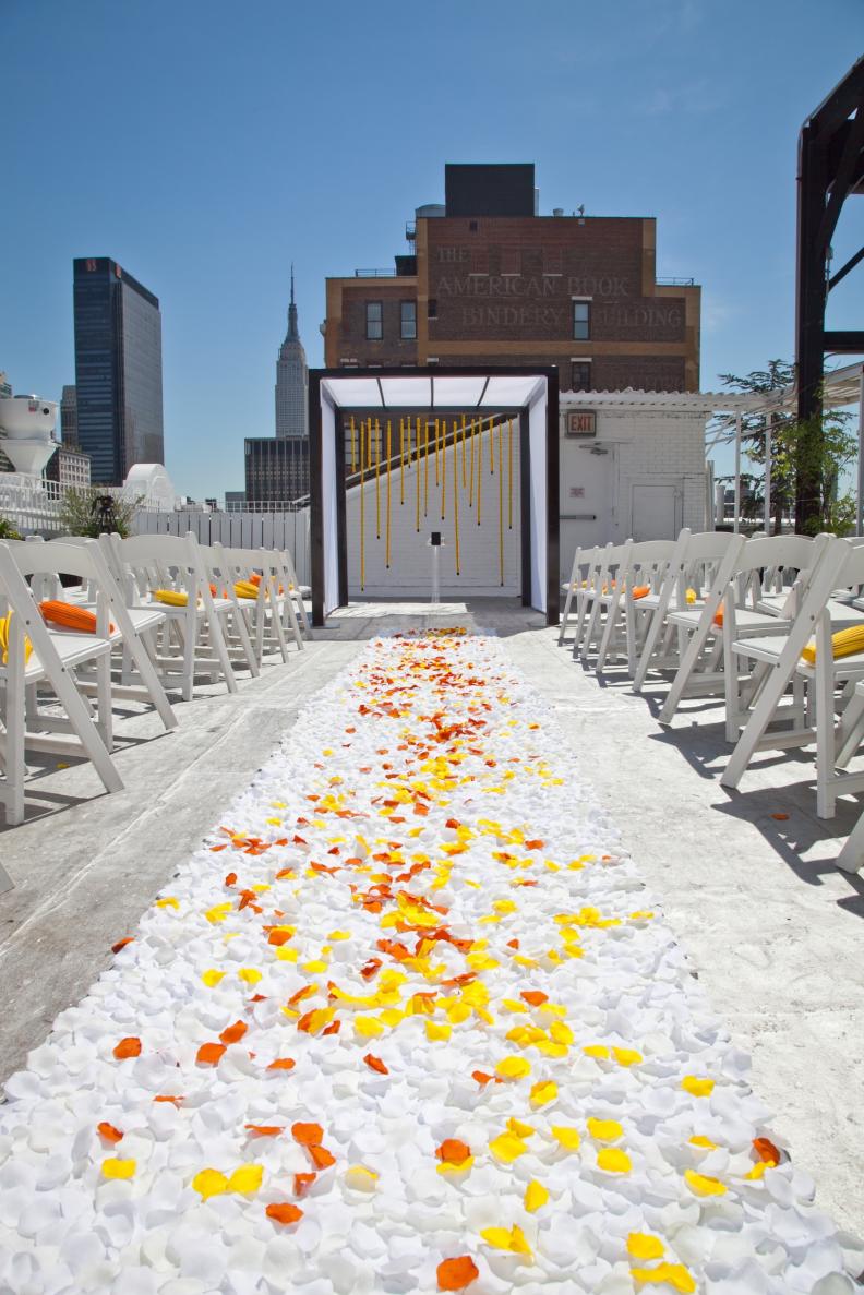 "The chuppah, a Jewish wedding canopy with four open sides and four poles, is a central part to every Jewish wedding," says Cigall Goldman, founder of Mazelmoments.com, a website full of resources for Jewish events. For this chuppah, NYC's Swank Productions created flower panels of yellow bottom mums for the backdrop, which complemented the couple's yellow-and-orange wedding theme.