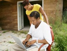 Couple with laptop by shed