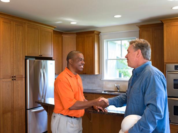 Contractor and Homeowner Shake Hands On Renovation Contractor and Homeowner Shake Hands On Renovation