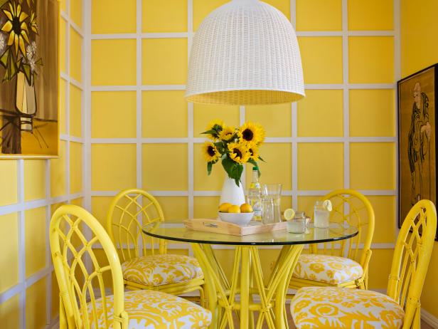 Yellow Dining Room With Lattice Wall, Glass Table and Woven Pendant