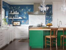 Kitchen With White Cabinets, Blue Wallpaper and Green Island