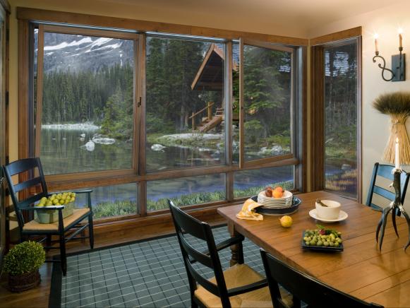 Neutral Dining Room With Check Rug, Wall of Windows, Country Furniture