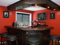 Red Bar With Custom Woodwork and Barstools