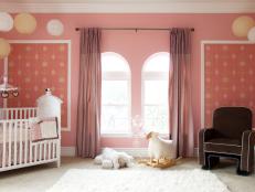 Pink Nursery With Paper Lanterns and Arched Windows