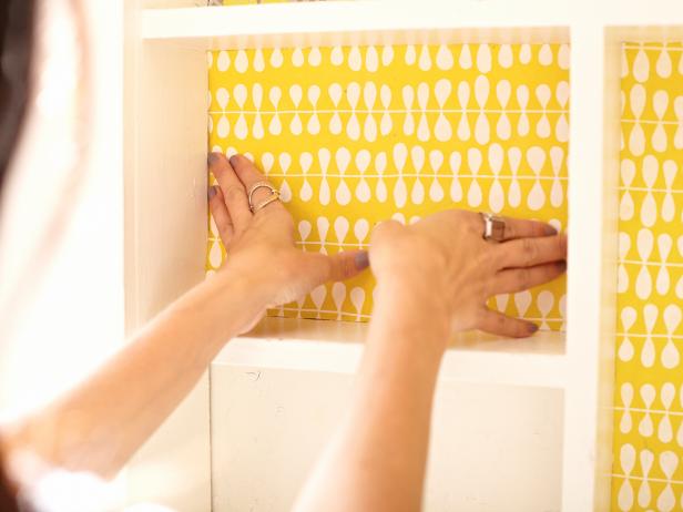 Go out and grab some gorgeous papers to line your cabinet. The fancy heavy wrapping paper at your favorite stationary store will work great, but you can also use wallpaper or contact paper for a more durable install. Cut your papers to fit the back wall spaces on the medicine cabinet.