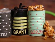Need a budget-friendly gift idea for a group? These personalized DIY snack tins filled with delicious homemade salted caramel popcorn are both thoughtful and easy to make. No chance they'll re-gift!