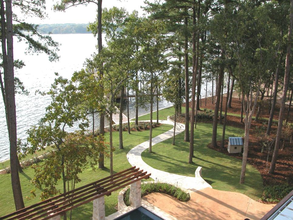 Backyard With Concrete Walkway to Dock Outdoor Patio With Path To Dock and Doghouse
