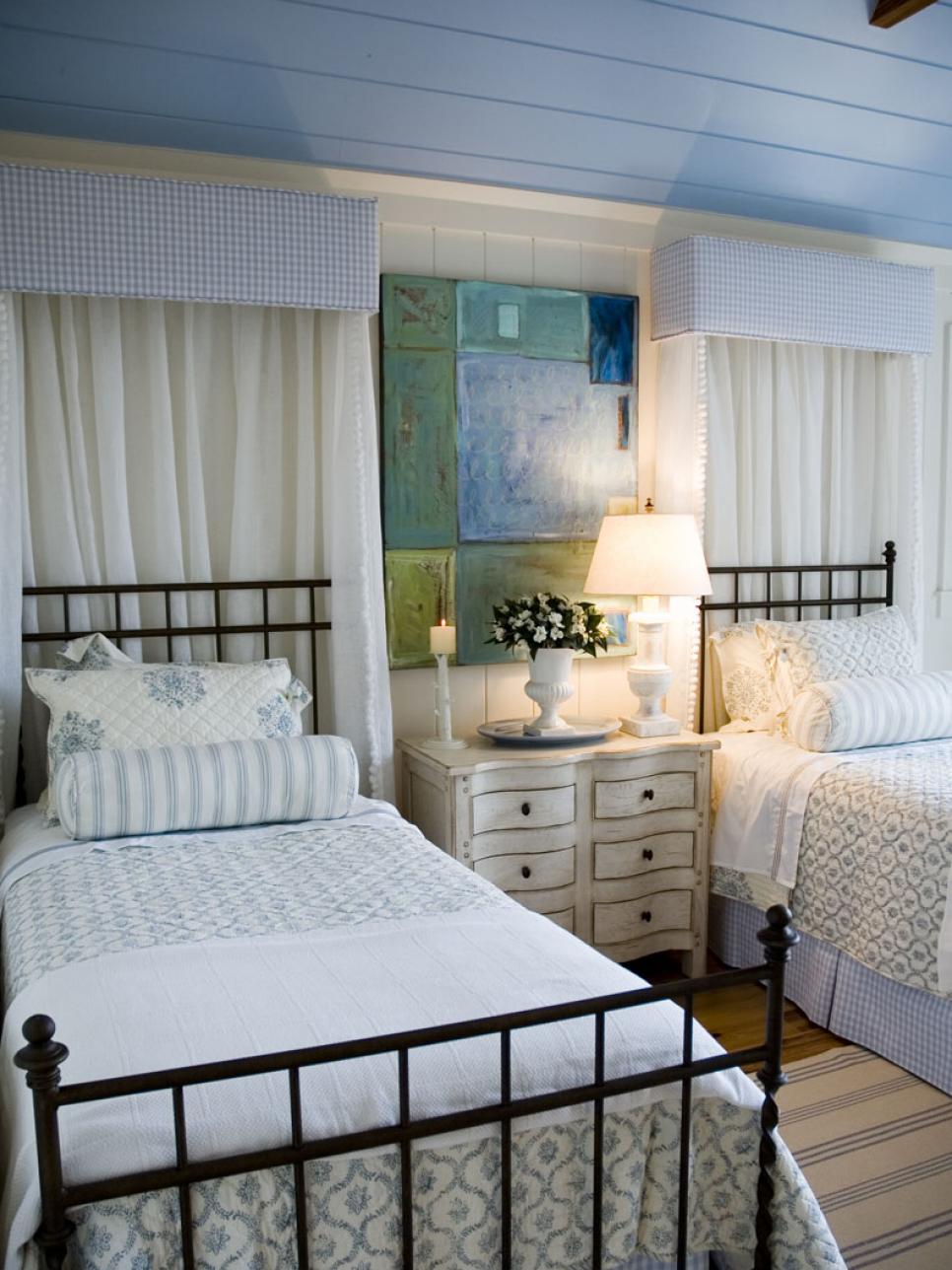 Blue and White Bedroom With Twin Beds, Cornices and Distressed Dresser