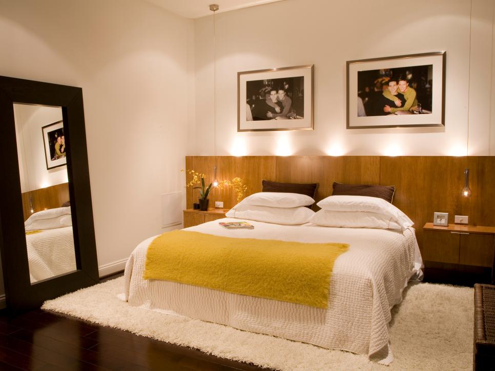 Bedroom With White Bedding, Extended Wood Headboard and Mirror