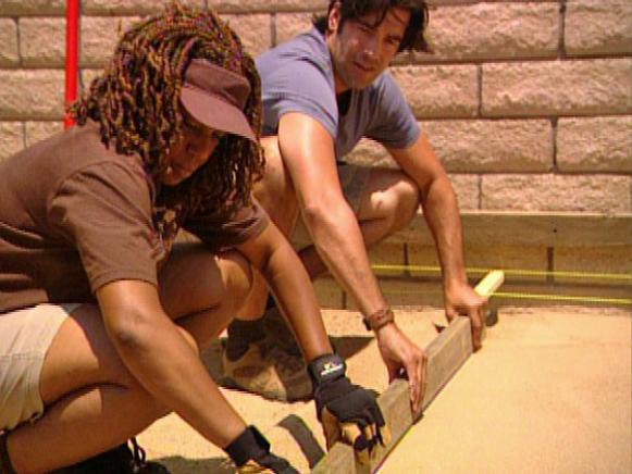 Smooth Sand to Lay a Backyard Patio Carter Oosterhouse and Woman Use 2x4 to Smooth Sand for Patio Installation