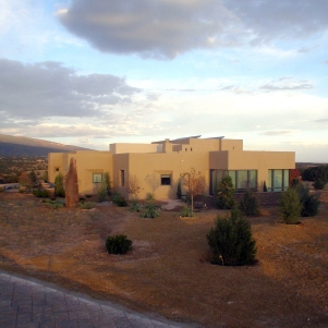 Exterior view of stucco home and desert landscape