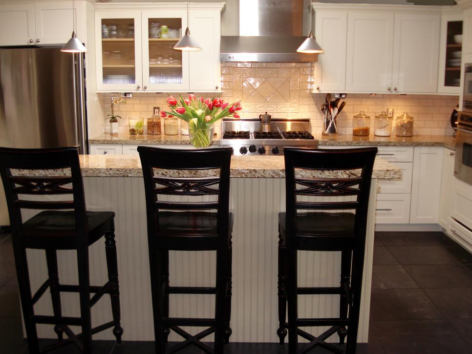 Contemporary White Kitchen With Granite Countertop and Ceramic Tile Backsplash