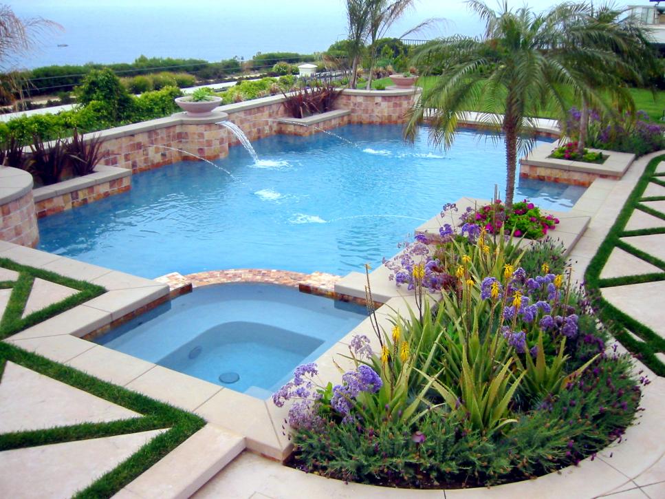 Backyard Pool With Tile Wall, Fountains and Multicolor Plants
