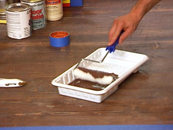 Paint Roller in Brown Paint in Ribbed Tray