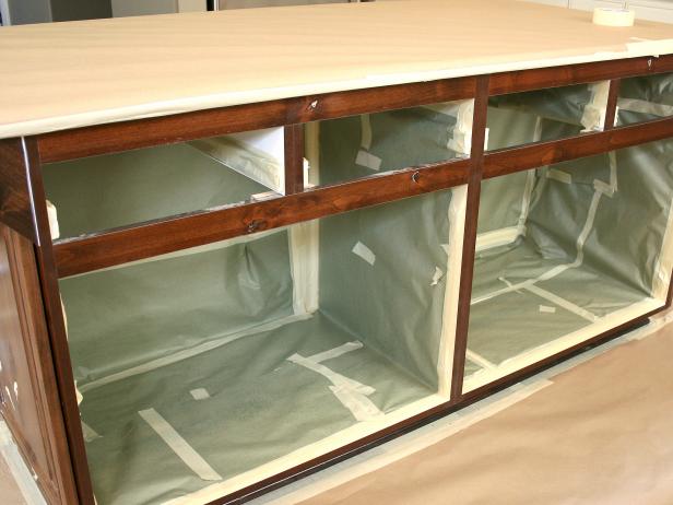 A kitchen island, with the interior protected with masking paper. 