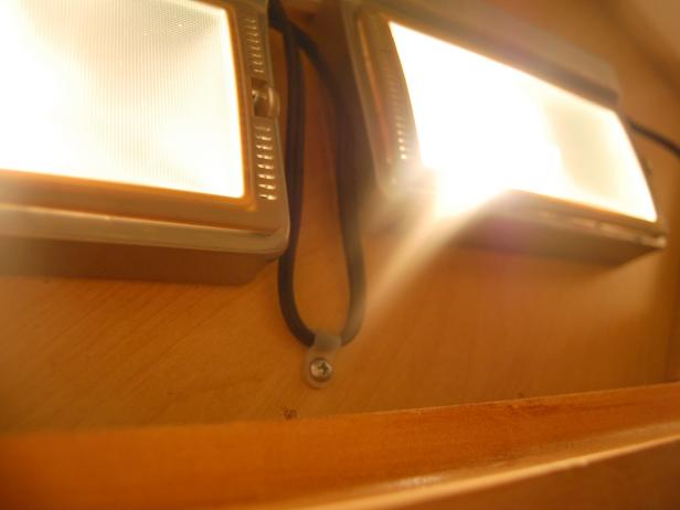 Mount lights and cords under cabinet