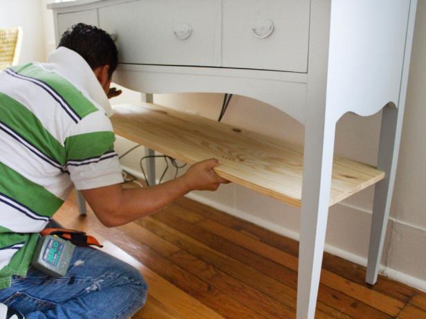 Man measuring shelf against dresser.