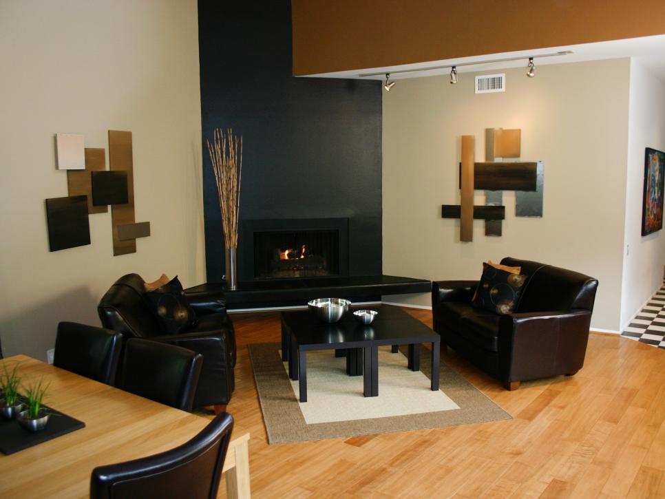Sleek Sitting Area and Adjacent Dining Space With Black Fireplace 
