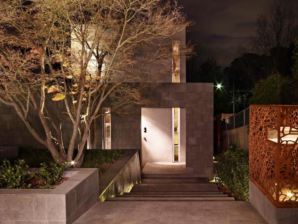 Stone Entrance and Walkway With Orange Sculpture Stone Home Entrance with Cascading Water Feature