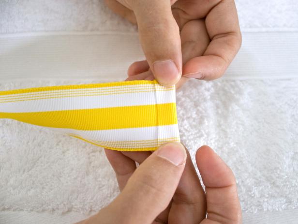 Folding and Pressing End of Ribbon With Glue