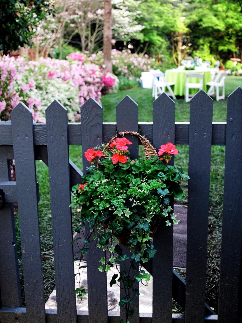 Cottage Garden With Floral Basket on Black Picket Fence