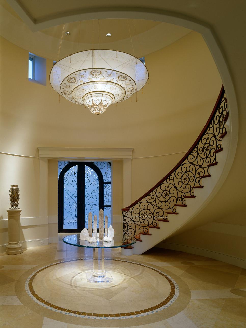 Elegant Foyer With Large Chandelier and Staircase 