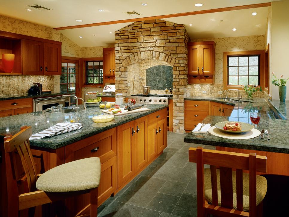 Eat-In Kitchen With Wood Cabinetry and Tall Stone Range Alcove