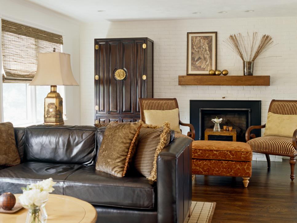 White Living Room with Black Leather Sofa, Gold Lamp & Black Armoire
