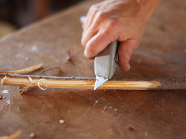 Whittle branches to remove bark and create a point at one end.