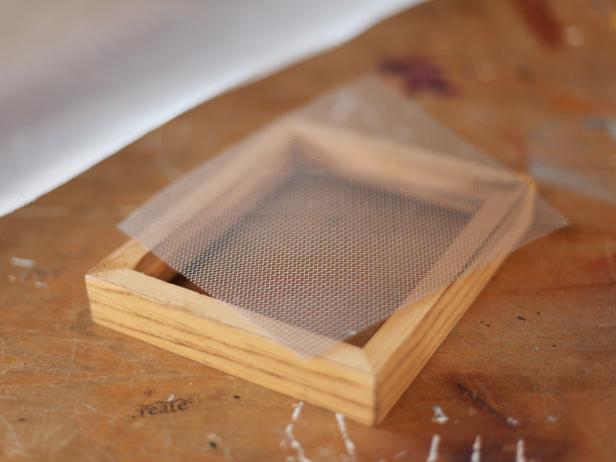 Empty Wooden Picture Frame and Small Square of Window Screen