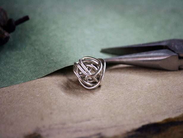 Simply twist, turn and tuck wire ends to create a nest shape that will accommodate the small decorative bird.