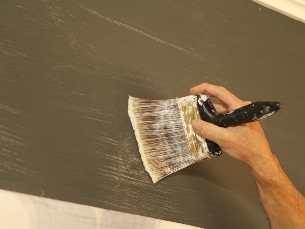 Prepare Walls With Wallcovering Primer Paintbrush Applying Wallcovering Primer to Wall