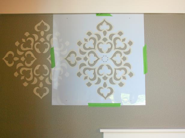 Stencil Taped Beside Painted Pattern on Gray Wall
