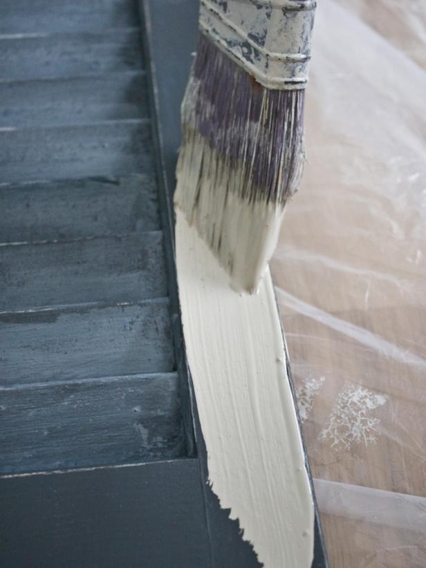 Paintbrush Coating Old Blue Shutter With Light Gray Paint