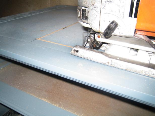 Following the measurements made on top of the vanity, carefully cut out the area for the new sink.