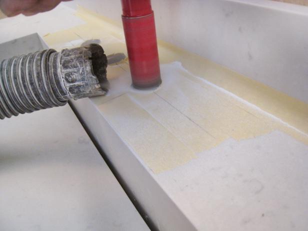 Use a 3/8" drill bit to cut the holes in your countertop. Note: It's a good idea to tape off the area between the counter and backsplash to prevent dust and debris from getting into that area when drilling. Once you're finished cutting the holes, remove the tape.