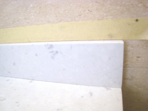 Caulk the seams where the backsplash meets the wall and countertop. If you're using a drop-in sink, you should also caulk the seam between the sink and countertop.