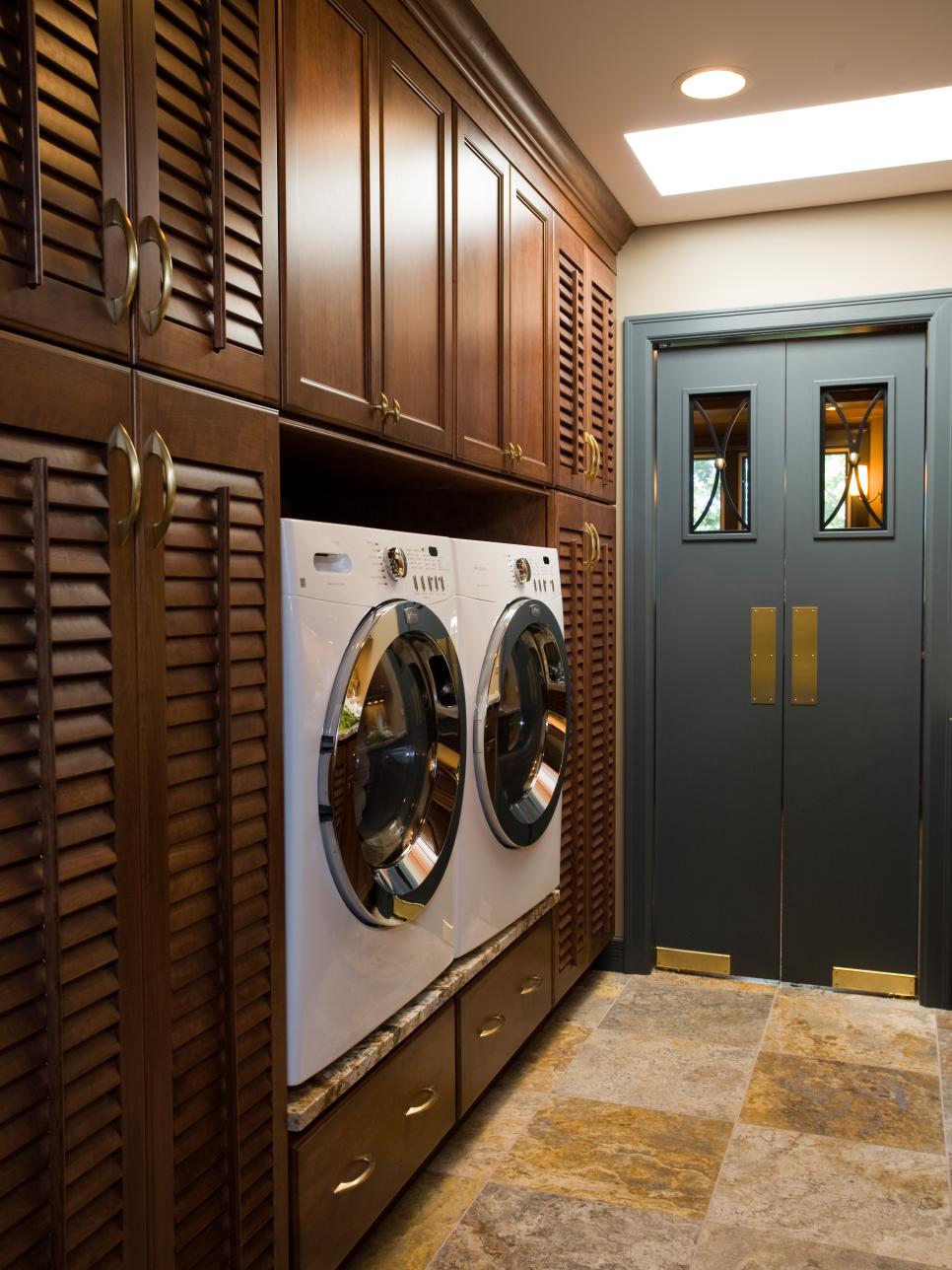 Traditional Laundry Area With Wood Cabinet Wall and Blue Double Doors