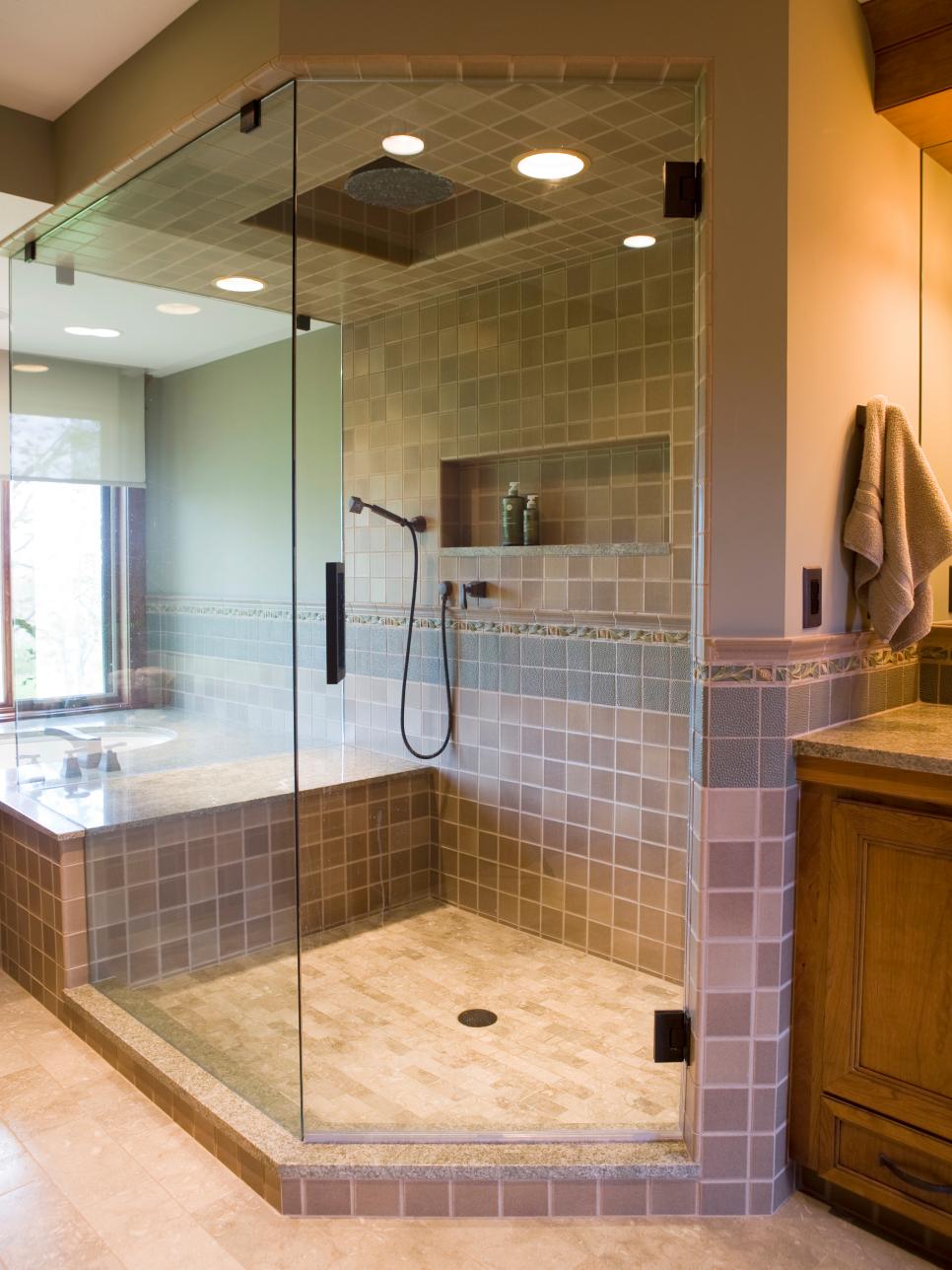 Neutral Toned Glass Shower With Tile Accents and Recessed Shelving