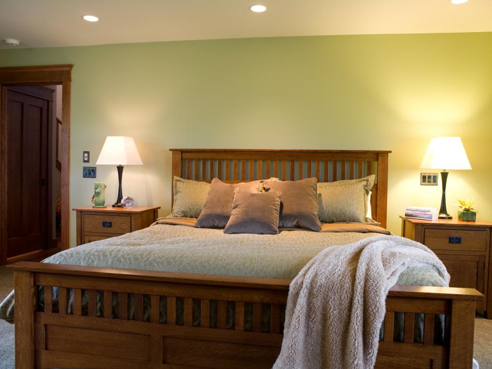 Traditional Bedroom With Wood Bed Frame and Green Wall
