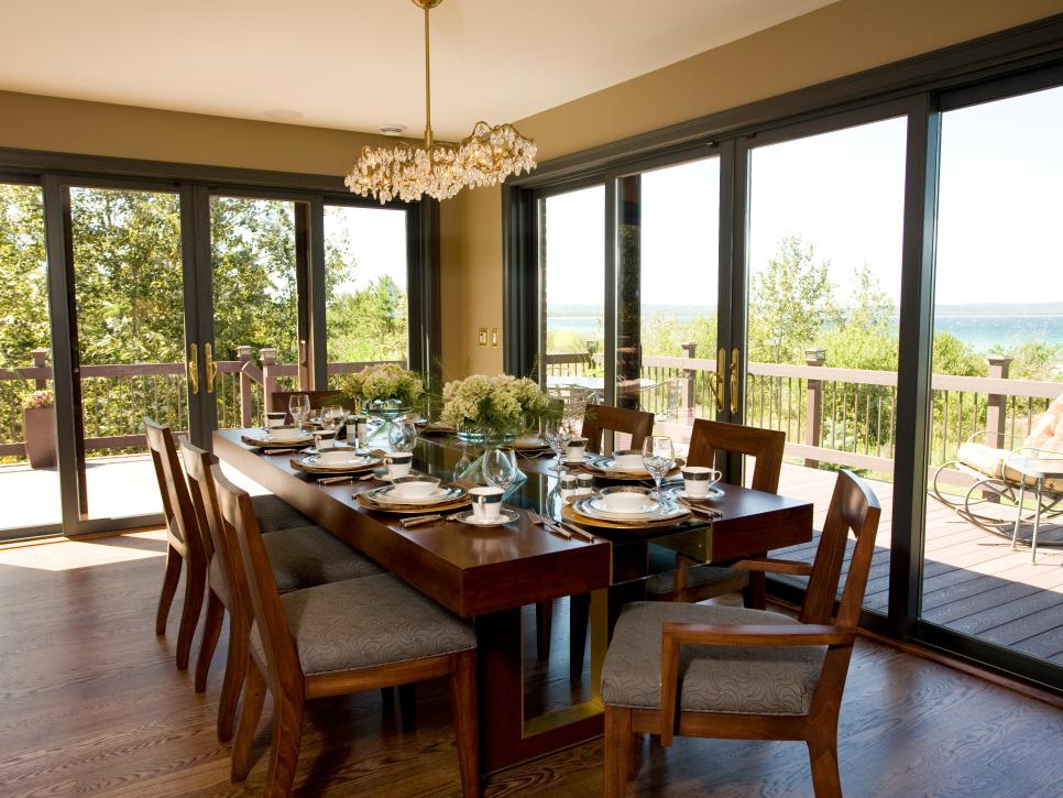 Transitional Dining Room With Large Windows and Wooden Table