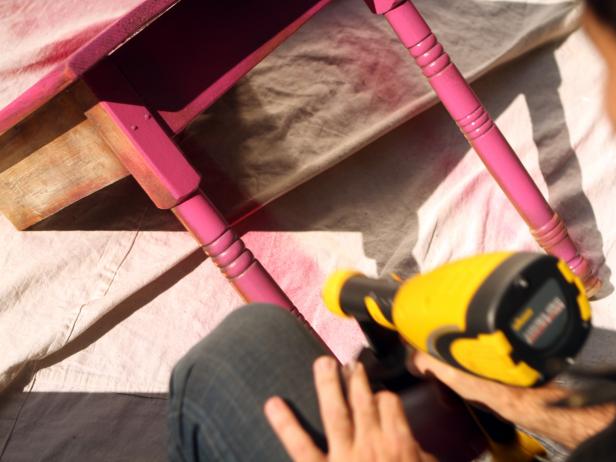 Apply an even base coat to table, keeping about eight inches' distance between table and sprayer to avoid paint buildup and dripping. Allow at least one hour for base coat to dry then apply a final coat.