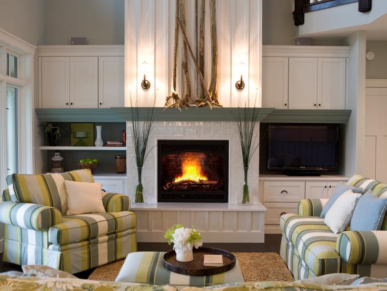 Living Room With Green and White Chairs and White Tile Fireplace